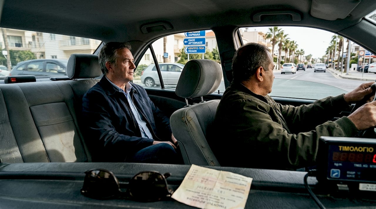 Ένας επιβάτης ταξί στη Λάρνακα παρατηρεί προσεκτικά το περιβάλλον γύρω του.